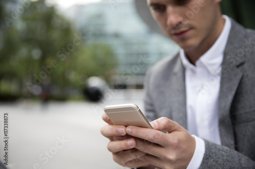 Image result for picture of a man checking his phone for messages at the office