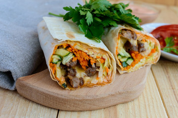 Shawarma - Middle East (Arabic) dish of pita (lavash) stuffed with: grilled meat, sauce, vegetables