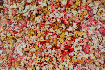 Colorful sweet popcorn with white vignette for texture or background 
