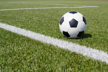 Obraz na płótnie Canvas soccer ball on the green field