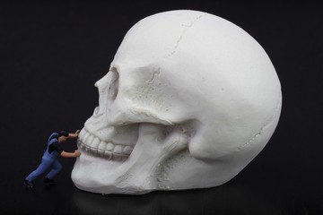 miniatura di uomo sche spinge via la morte
