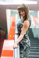 Beautiful Russian girl posing in office hall against the wall