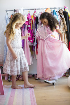 Two little girls trying on clothes