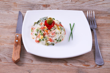 vegetable salad in a bowl on wooden background