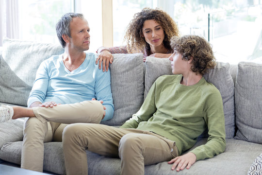 Family having a discussion in living room at home