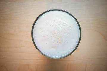 Glass of fresh lager beer on wooden table. vintage color