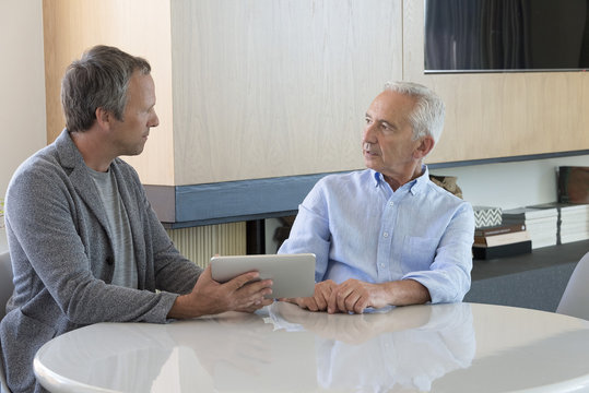 Senior man meeting with financial advisor at home
