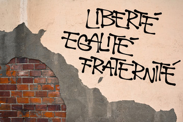 French text Liberte, Egalite, Fraternite ( Liberty, Equality, Fraternity ) - Handwritten graffiti on the wall, anarchist aesthetics. Revolutionist motto. Appeal to fight for republic and constitution