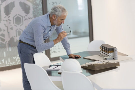 Design professional examining architectural model in an office