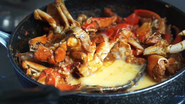 Cooking Singaporean signature dish, Chilli crab. Popular seafood dish 