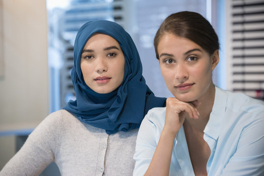 Portrait of two business professionals smiling in an office