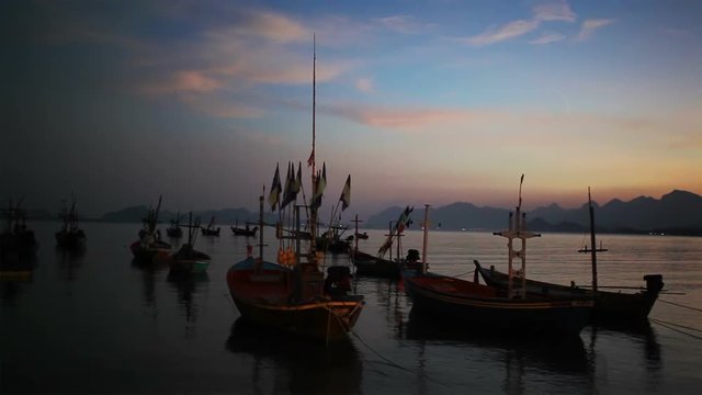 Group of fishing boat anchored at Pranburi beach in Thailand, taken on twilight sunset scene