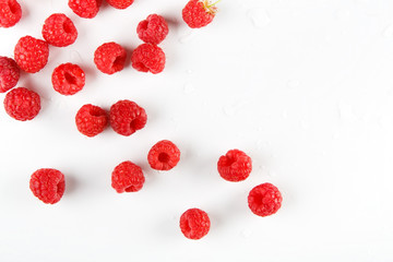 Red fresh raspberries on white background