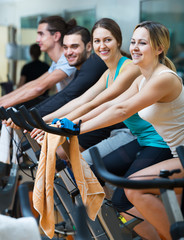 Adults riding stationary bicycles