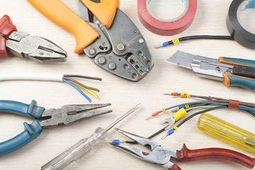 Set of electrical tool on wooden background. Accessories for engineering work, energy concept.