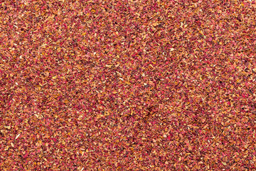 Organic dry rose petals (Rosa × centifolia) in tea cut size. Macro close up background texture. Top view.
