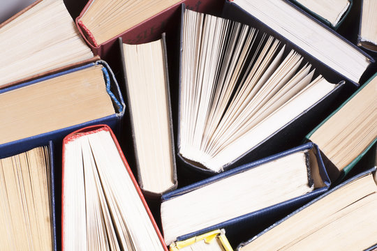 Open book, hardback books on wooden table. Education background. Back to school. Copy space for text.