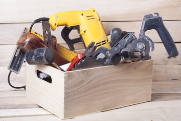 Construction tools on wooden table with sawdust. Joiner carpenter workplace top view. Copy space for text