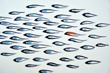 Feeling unique in the crowd orange fish among blue