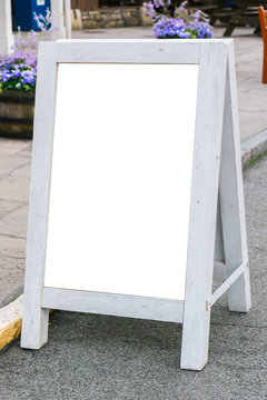 Blank white signboard stand on storefront.