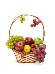 grapes, apples and lemon in a wicker basket