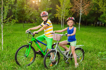 Fototapeta na wymiar Children on bicycles in a field of grass