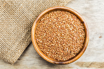 Bowl with Buckwheat on a wooden background