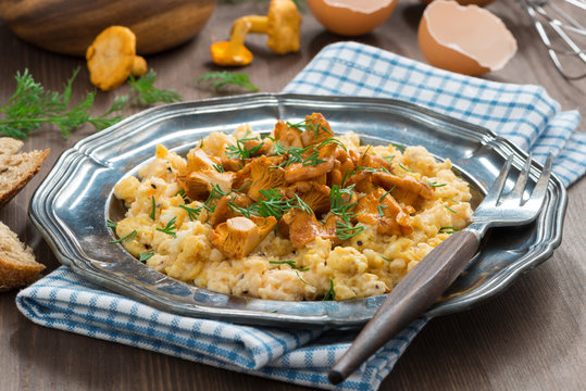 scrambled eggs with chanterelles and herbs, horizontal