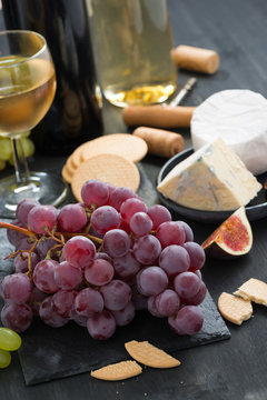 snacks - grapes, cheese and wine, vertical