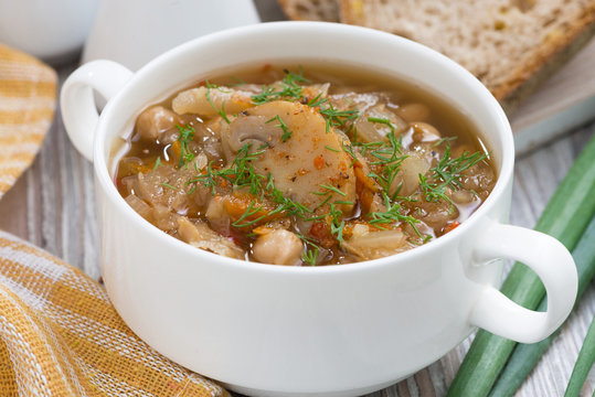 soup with cabbage and mushrooms in bowl, closeup