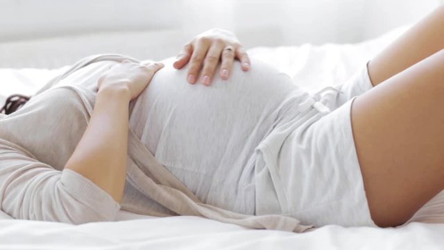 happy pregnant woman touching her tummy at home 63