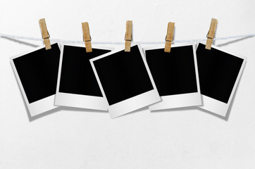 Blank photo frame with clothespin hanging.