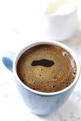 Coffee with milk for a breakfast.
