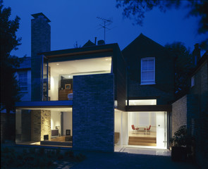 Rear elevation of a house at dusk.