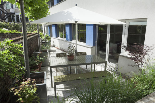 Outdoor dining area with modern furniture and parasol