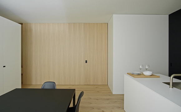 White, Open Planned, Kitchen And Dining Area With Modern Furniture And Features With Kitchen Island With Sink.