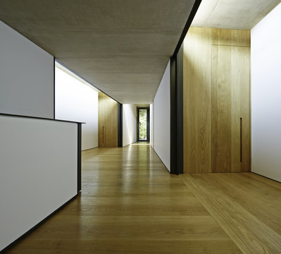 View of the hallway with black and white walls and minimal decoration.