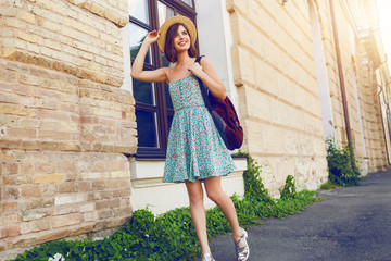 Sunny lifestyle fashion portrait of young stylish hipster woman wearing straw hat.