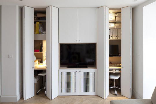 Renovated House in Tooting, London. Part of the Totterdown Estate constructed between 1903-1911. Built in cupboards and TV showing hidden work desks.