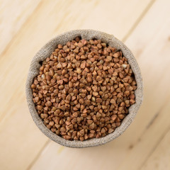 buckwheat in a linen bag in background grain bread