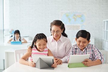 Vietnamese children having geography lesson in class