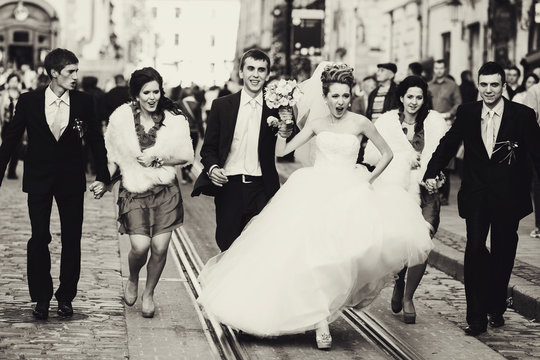 A balck and white picture with warlike bride walking with friend