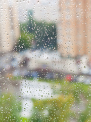 raindrops on window and blurred cityscape