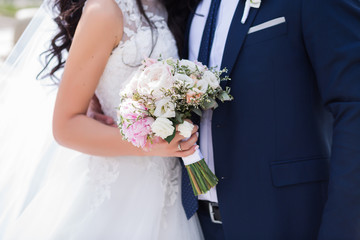 Beautiful wedding bouquet in hands of the bride