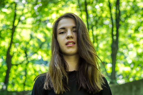 Young beautiful teenager girl with hair dlinnіmi Strіyskom walks in the park in Lviv