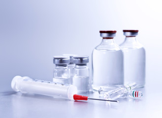 Vials and syringe, studio shot. Medical objects for vaccination. Vaccine drew up into a syringe. 