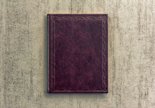 purple book on a grey grunge background, top view, retro toned image