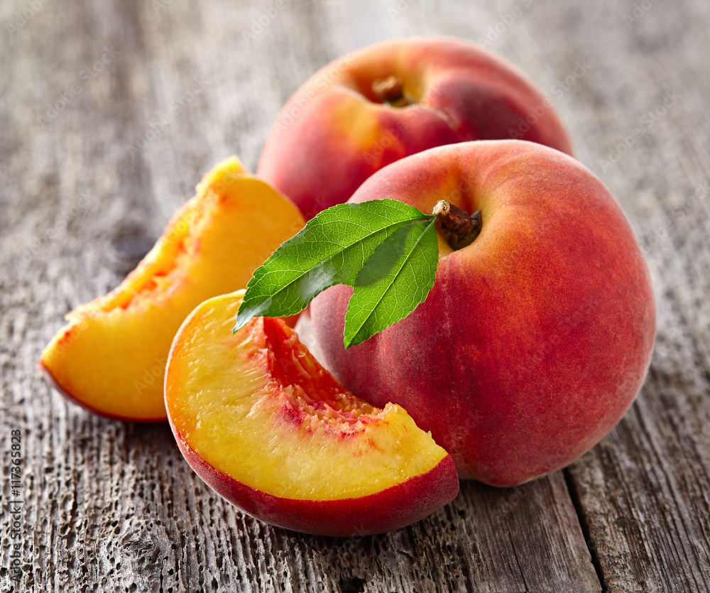 Poster fresh peaches on a wooden board