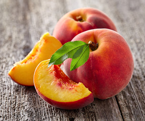 Fresh peaches on a wooden board © Dionisvera