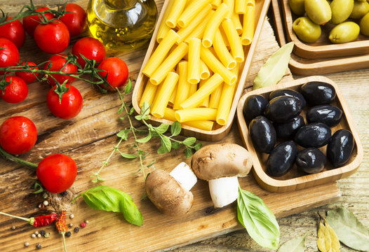 Italian pasta ingredients with mushrooms,tomatoes,olives,herbs a